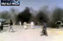 In this image taken from video obtained Thursday, Sept. 20, 2012 from the Ugarit News, which has been authenticated based on its contents and other AP reporting, people are seen after an airstrike on a gas station in Raqqa, Syria. Syrian opposition activists said a regime airstrike hit a gas station in the north of the country Thursday, setting off an explosion that killed and wounded dozens of people. (AP Photo/Ugarit News via AP video)