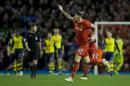 Liverpool's Martin Skrtel, centre right, celebrates after scoring a late goal against Arsenal during the English Premier League soccer match between Liverpool and Arsenal at Anfield Stadium, Liverpool, England, Sunday Dec. 21, 2014. (AP Photo/Jon Super)