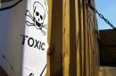 In this photo taken on Tuesday, May 13, 2014, a sticker reading "Toxic" on containers carrying Syria's dangerous chemical weapons, on the Danish cargo ship, Ark Futura, transporting the chemical weapons out of the strife-torn country, in Cyprus coastal waters. Organization for the Prohibition of Chemical Weapons director general Ahmet Uzumcu said Monday, June 23, 2014, the final shipment of stockpiled chemical weapons has been loaded onto Danish and Norwegian ships for transportation out of Syria.(AP Photo/Petros Karadjias)