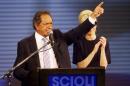 Daniel Scioli, Buenos Aires' province governor and presidential candidate, gestures as he speaks next to his wife Karina Rabolini in Buenos Aires