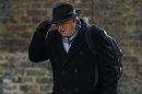 Britain's Business Secretary Vince Cable holds on to his hat as he arrives to attend a Cabinet meeting at Number 10 Downing Street in London