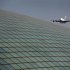 An Emirates airlines Airbus A380 comes in for landing over the roof of the Beijing Capital International Airport's train station