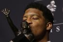 Florida State quarterback Jameis Winston kisses the Heisman Trophy while posing for photographers after winning the trophy, Saturday, Dec. 14, 2013, in New York. Winston, 19, is the youngest winner of the trophy and the second straight player to win the prestigious award in his first year of college. (AP Photo/Julio Cortez)
