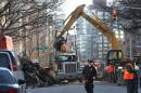 Rubble is moved Sunday, March 29, 2015, at the site of an apparent gas explosion that took place three days earlier in the East Village neighborhood of New York. (AP Photo/Tina Fineberg)
