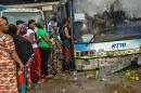 People queue to vote for the Presidential elections at a polling booth constructed in a run-down bus in Conakry on October 11, 2015