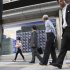 People walk by an electronic stock indicator in Tokyo Wednesday, Sept. 12, 2012 as Japan's Nikkei 225 index rose 1.7 percent to close at 8,959.96. (AP Photo/Shizuo Kambayashi)