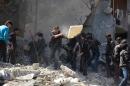 Syrians dig through the rubble of a building in search of survivors in the rebel-held area of Douma, east of the capital Damascus, following reported air strikes by regime forces on March 13, 2015