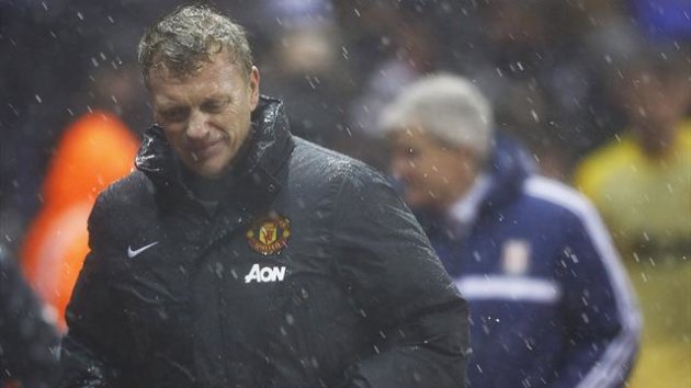 Manchester United's manager David Moyes (L) leaves the pitch after referee Mark Clattenburg (not pictured) suspended play temporarily due to bad weather during their English League Cup quarter-final match against Stoke City at the Britannia (REUTERS)