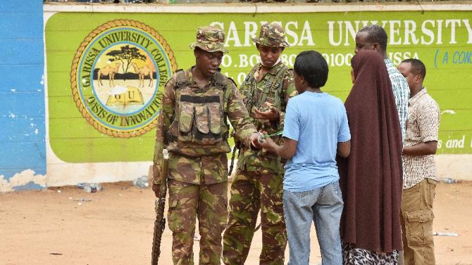 Kenyan soldiers search and question people at the front entrance of Moi University in Garissa on April 3, 2015