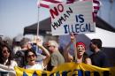 Demonstrators picket before the possible arrival of undocumented migrants who may be processed at the Murrieta Border Patrol Station in Murrieta, California