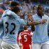 Manchester City's Toure celebrates his goal against QPR with Tevez and Lescott during their English Premier League soccer match at The Etihad Stadium in Manchester