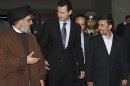 FILE -- In this Thursday February 25, 2010 file photo, released by the Syrian official news agency SANA, Hezbollah leader sheik Hassan Nasrallah, left, speaks with Syrian President Bashar Assad, center, and Iranian President Mahmoud Ahmadinejad, right, upon their arrival for a dinner, in Damascus, Syria. Syria's civil war has morphed into a proxy fight in which Shiite Iran has strongly backed Assad, while Sunni Arab nations have backed rebels. Many Sunni hard-liners around the Mideast have taken Hezbollah's intervention in Syria almost as a declaration of war by Shiites against Sunnis. (AP Photo/SANA, File)