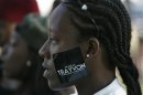 A woman wears a sticker supporting Trayvon Martin during a peaceful protest of the acquittal of George Zimmerman for the 2012 shooting death of Martin, in Los Angeles, California July 15, 2013. REUTERS/Jonathan Alcorn