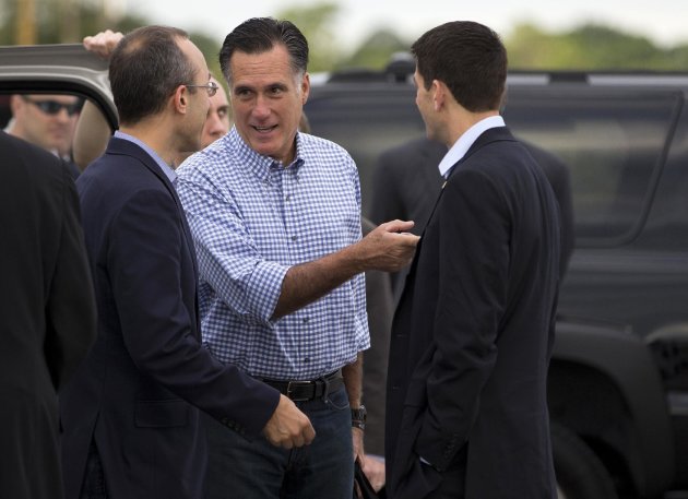 Republican presidential candidate, former Massachusetts Gov. Mitt Romney, center, talks with foreign policy adviser Dan Senor, left, and his vice presidential running mate, Rep. Paul Ryan, R-Wis., before boarding his campaign plane at Daytona International Airport, Saturday, Oct. 20, 2012, in Daytona Beach, Fla. (AP Photo/ Evan Vucci)