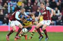 Arsenal's Alexis Sanchez, center, in action with Burnley's Michael Duff, right, and David Jones during the English Premier League soccer match at Turf Moor, Burnley, England, Saturday April 11, 2015. (AP Photo/PA, Dave Howarth) UNITED KINGDOM OUT NO SALES NO ARCHIVE