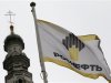 A flag with a logo of Russian state oil firm Rosneft is seen at its office in Moscow