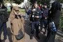 French police and gendarmes check identity cards of women wearing full-face veils, or niqab, as they arrived to demonstrate after calls on the internet by Islamic groups to protest over an anti-Islam video, in Lille