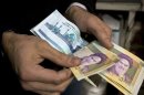Vendor counts money in shop in Tehran's Grand Bazaar