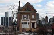 A vacant, boarded up house is seen in the once thriving Brush Park neighborhood with the downtown Detroit skyline behind it in Detroit, Michigan March 3, 2013. REUTERS/ Rebecca Cook