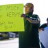 Green Bay Packers fan Mike LePak holds a sign Tuesday, Sept. 25, 2012 on Lombardi Avenue in Green Bay, Wisc., in protest of a controversial call in the Packers 14-12 loss to the Seattle Seahawks, Monday night in Seattle. Just when it seemed that NFL coaches, players and fans couldn't get any angrier, along came a fiasco that trumped any of the complaints from the weekend.  (AP Photo/The Green Bay Press-Gazette, Lukas Keapproth ) NO SALES