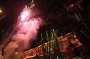 A chef with a restaurant enjoys fireworks to celebrate the fifth day of Chinese New Year in Beijing, China, Monday, Feb. 7, 2011. (AP Photo/Ng Han Guan)