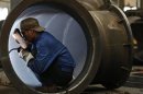 An employee welds a water turbine at a factory in Jinhua, Zhejiang province