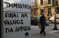 <p>               An elderly man passes graffiti that reads in Greek: ''Terrorism = Job Seeking'' in the northern Greek port city of Thessaloniki, Thursday, Jan. 10, 2013. Unemployment has reached new highs in Greece, with October 2012 figures showing the jobless rate at 26.8 percent, a major increase from the same month in 2011. (AP Photo/Nikolas Giakoumidis)