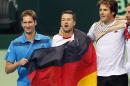 Germany's Florian Mayer, Philipp Kohlschreiber and Tommy Haas, from left, celebrate during a Davis Cup World Group first round tennis match between Germany and Spain in Frankfurt, Germany, Saturday, Feb. 1, 2014. Germany has now a 3-0 lead and advances to the next round. (AP Photo/Michael Probst)