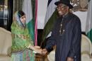 Pakistani activist Malala Yousafzai, left, shakes hands with Nigerian President, Goodluck Jonathan, right, at the Presidential villa, in Abuja, Nigeria, Monday, July 14, 2014. Yousafzai on Monday won a promise from Nigeria's leader to meet with the parents of some of the 219 schoolgirls held by Islamic extremists for three months. Malala celebrated her 17th birthday on Monday in Nigeria with promises to work for the release of the girls from the Boko Haram movement. (AP Photo)