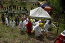 Forensic personnel and rescue workers carry the body of one of the fifteen miners trapped by the collapse of a gold mine, near the area of El Saibo, in Riosucio, Colombia on May 15, 2015