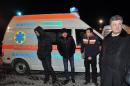 Ukrainian businessman and opposition politician Petro Poroshenko (R) and activists stand in front of an ambulance carrying injured Ukrainian protester Dmytro Bulatov at Kiev's Boryspil International Airport on February 2, 2014