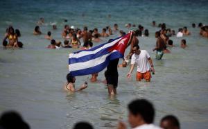 In this Aug. 6, 2014, file photo, a man waves a Cuban&nbsp;&hellip;