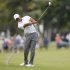 Woods hits his approach shot into the 18th green during third round play in the 2013 WGC-Cadillac Championship PGA golf tournament in Doral