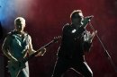 Lead singer Bono of Irish rock band U2 performs with Adam Clayton during their 360 Degree Tour at King Baudouin Stadium in Brussels