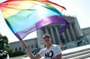 A gay rights activist waves a rainbow flag in front of the US Supreme Court in Washington, DC