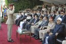 In this image released by the Egyptian President, an Egyptian military officer salutes President Mohammed Morsi, third from right, as he sits with Prime Minister Kamal el-Ganzouri, center, Field Marshal Hussein Tantawi, fourth right, Army Chief of Staff Gen. Sami Anan, second right, and the Grand Sheik of Al-Azhar, Ahmed el-Tayyib, right, at a graduation ceremony at a military base east of Cairo, Egypt, Monday, July 9, 2012. Egypt's highest court insisted Monday that its ruling that led to the dissolution of the Islamist-dominated parliament was final and binding, setting up a showdown with the country's newly elected president. The announcement on state TV came a day after President Mohammed Morsi recalled the legislators, defying the powerful military's decision to dismiss parliament after the Supreme Constitutional Court ruled that a third of its members had been elected illegally.(AP Photo/Sheriff Abd El Minoem, Egyptian Presidency)