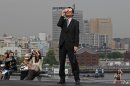 A business man watches an annular solar eclipse at a waterfront park in Yokohama, near Tokyo, Monday, May 21, 2012. Millions of Asians watched as a rare 