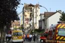 French rescue workers and firefighters inspect the site where a four-storey residential building collapsed following a blast in Rosny-sous-Bois in the eastern suburbs of Paris on August 31, 2014