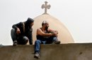 Egyptian Christians sit on the wall of the Coptic cathedral in Cairo, April 8.