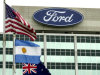 FILE - Ford Motor Company's logo is shown  atop its world headquarters in Dearborn, Mich., in this June 5, 2003 file photo. Ford's net income fell from $13.6 billion in the same quarter last year, but that figure included a big accounting-related gain it was announced Tuesday Jan. 29, 2013. Without that gain, Ford's earnings were up from $1 billion in the fourth quarter of last year. (AP Photo/Paul Sancya)