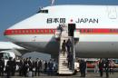 Japan's Prime Minister Shinzo Abe and his wife Akie board a government plane at Tokyo's Haneda Airport on November 17, 2016