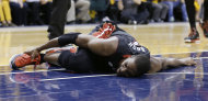 Miami Heat's Chris Bosh holds his ankle during the second half against the Indiana Pacers in Game 4 of the NBA basketball Eastern Conference finals, Tuesday, May 28, 2013, in Indianapolis. (AP Photo/Michael Conroy)