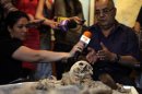 National History Museum head Dimitrov speaks to media near skeleton pierced with piece of iron in Sofia