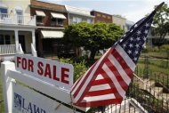 A U.S. flag decorates a for-sale sign at a home in the Capitol Hill neighborhood of Washington, August 21, 2012. REUTERS/Jonathan Ernst