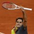 Federer of Switzerland waves after winning his match against Mahut of France during the French Open tennis tournament at the Roland Garros stadium in Paris