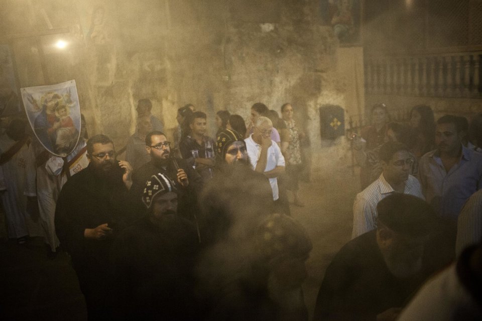 Coptics Priests and Monks purify with incense the holy cave during a procession within Al-Mahraq monastery in Assiut, Upper Egypt, Tuesday, Aug. 6, 2013. Islamists may be on the defensive in Cairo, but in Egypt's deep south they still have much sway and audacity: over the past week, they have stepped up a hate campaign against the area's Christians. Blaming the broader Coptic community for the July 3 coup that removed Islamist President Mohammed Morsi, Islamists have marked Christian homes, stores and churches with crosses and threatening graffiti. (AP Photo/Manu Brabo)