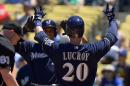 Milwaukee Brewers' Jonathan Lucroy, right, is congratulated by Carlos Gomez after hitting a two-run home run during the first inning of a baseball game against the Los Angeles Dodgers, Sunday, Aug. 17, 2014, in Los Angeles. (AP Photo/Mark J. Terrill)