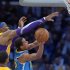 Los Angeles Lakers center Dwight Howard, left, blocks the shot of New Orleans Hornets guard Brian Roberts during the second half of their NBA basketball game, Tuesday, Jan. 29, 2013, in Los Angeles. The Lakers won 111-106. (AP Photo/Mark J. Terrill)