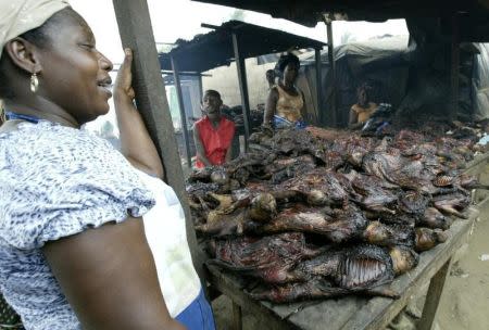 A woman stands by a table table selling smoked bush meat at a specialist market in the Yopougon area..