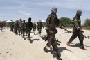 Al Shabaab soldiers patrol in formation along the streets of Dayniile district in Southern Mogadishu